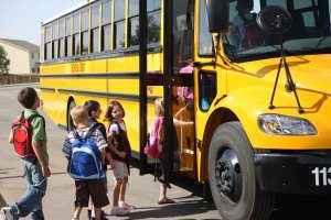 Children getting on school bus