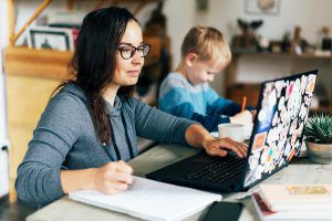 Woman sitting at laptop working from home during pandemic